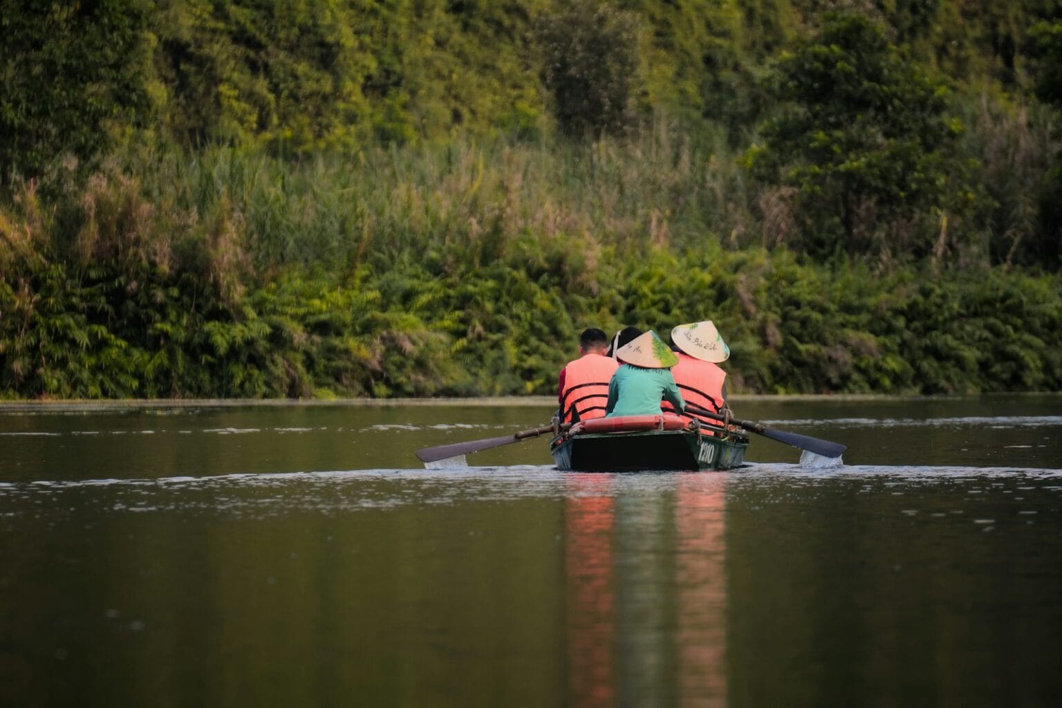 a couple of people in a small boat on a lake