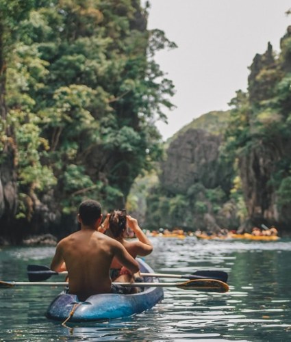a man and a woman in a kayak on a river