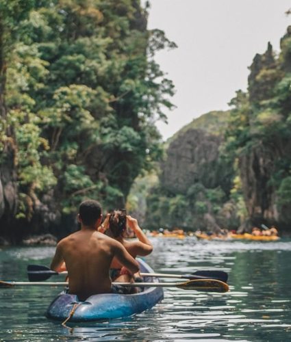a man and a woman in a kayak on a river